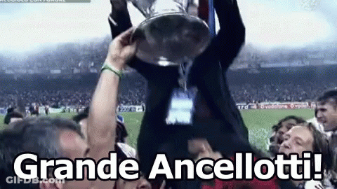 A Man Is Holding A Trophy In The Air With The Words Grande Ancellotti In The Corner GIF
