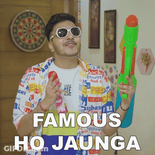 A Man Is Holding A Water Gun And Says Famous Ho Jaunga GIF