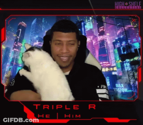 A Man Is Holding A White Cat In Front Of A Screen That Says Triple R On It GIF