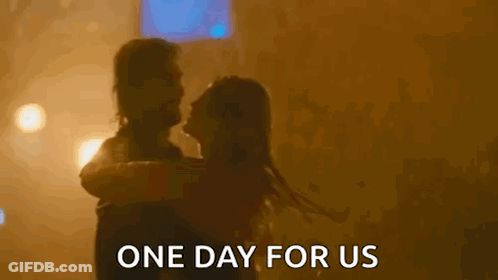 A Man Is Holding A Woman In His Arms And The Words `` One Day For Us '' Are Written Above Them . GIF