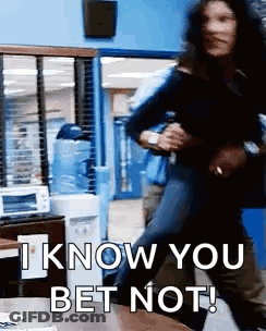 A Man Is Holding A Woman In His Arms In A Room And Says `` I Know You Bet Not '' . GIF