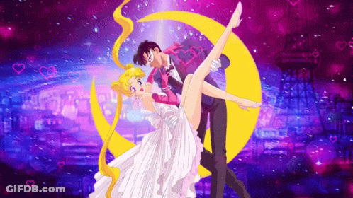 A Man Is Holding A Woman In His Arms In Front Of A Moon . GIF