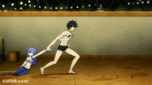 A Man Is Holding A Woman 'S Hand While She Lays On The Ground GIF