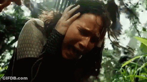 A Man Is Holding A Woman 'S Head In A Forest . GIF