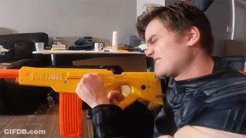 Man Holding Fortnite Yellow Toy Gun GIF