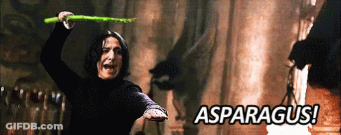 A Man Is Holding An Asparagus In His Hand With The Words Asparagus In The Background GIF
