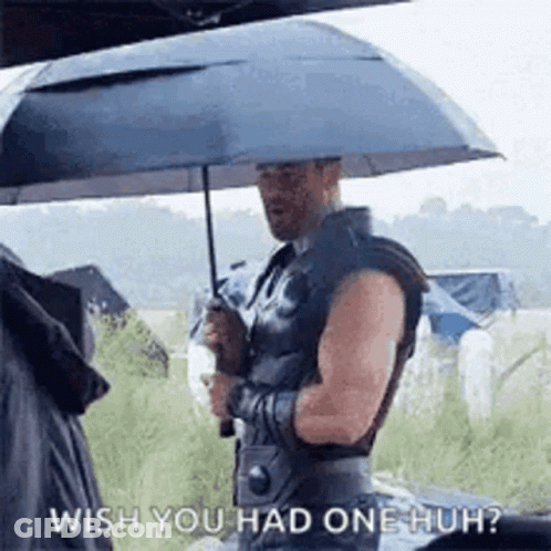 A Man Is Holding An Umbrella Over His Head And Saying `` Wish You Had One Huh '' . GIF