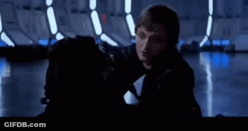 A Man Is Holding Another Man 'S Head In A Dark Room In A Star Wars Movie . GIF