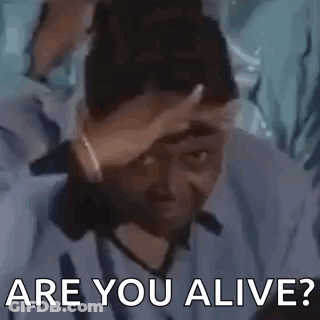 A Man Is Holding His Hand To His Forehead And Asking Are You Alive . GIF
