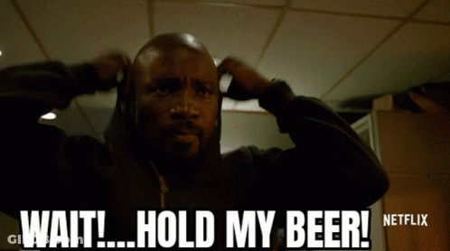 A Man Is Holding His Hands To His Ears And Says Wait Hold My Beer GIF