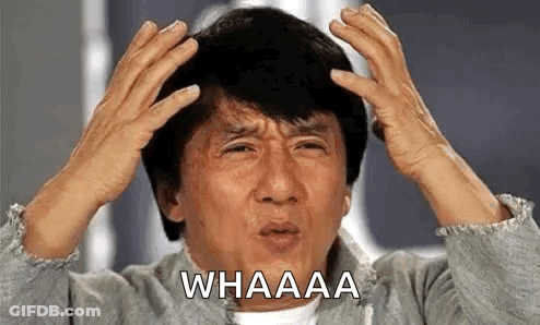 A Man Is Holding His Head With His Hands While Making A Funny Face . GIF