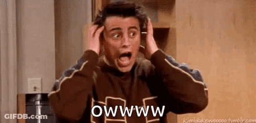 A Man Is Holding His Head With His Hands While Making A Surprised Face . GIF