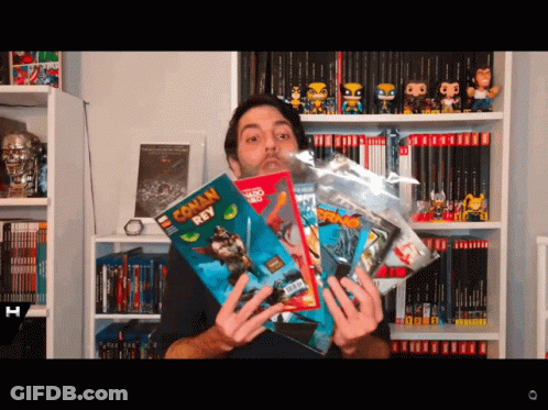 Man Holding Conan Roy Comic Book GIF