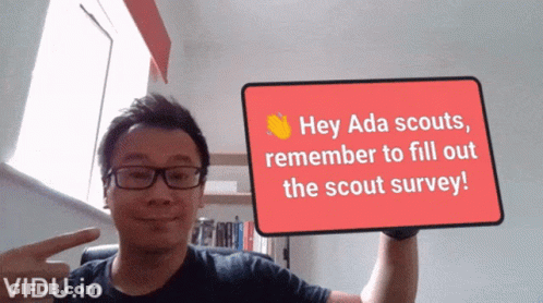 A Man Is Holding Up A Sign That Says Hey Ada Scouts Remember To Fill Out The Scout Survey GIF