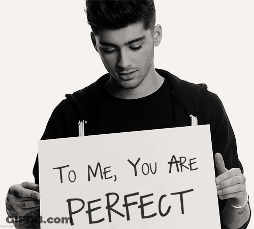 A Man Is Holding Up A Sign That Says To Me You Are Perfect GIF