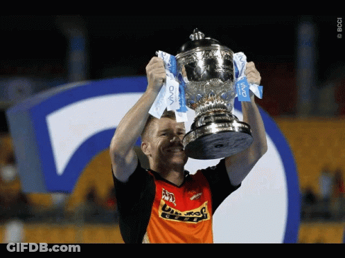 A Man Is Holding Up A Trophy That Says Vivo GIF