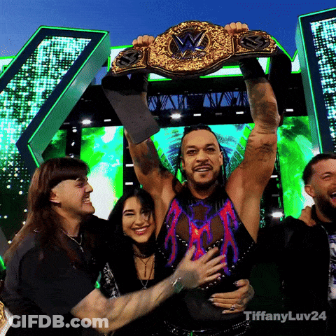 A Man Is Holding Up A Wrestling Championship Belt With Tiffanyluv24 Written Below Him GIF