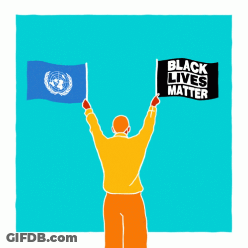 A Man Is Holding Up Two Flags And A Sign That Says Black Lives Matter GIF