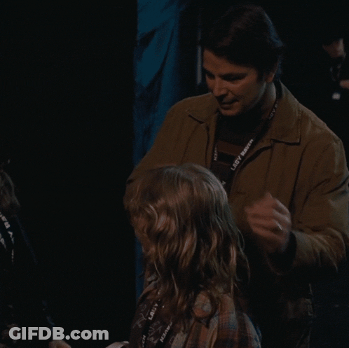 A Man Is Hugging A Little Girl With A Lanyard That Says Lady Raven On It GIF