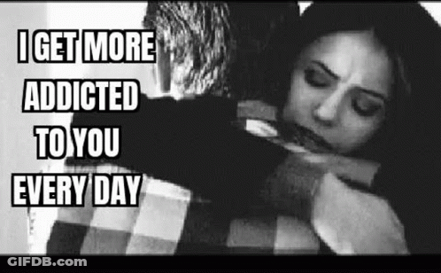 A Man Is Hugging A Woman In A Black And White Photo With The Caption `` I Get More Addicted To You Every Day '' . GIF