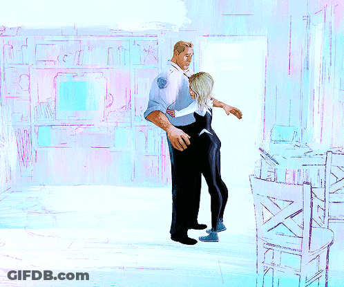 A Man Is Hugging A Woman In A Room With Chairs GIF