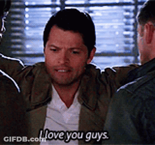 A Man Is Hugging Another Man And Saying `` I Love You Guys '' While Standing In Front Of A Window . GIF