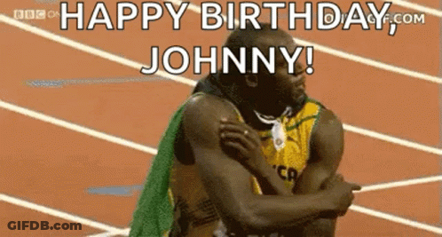 A Man Is Hugging Another Man On A Track And Says `` Happy Birthday Johnny ! '' GIF