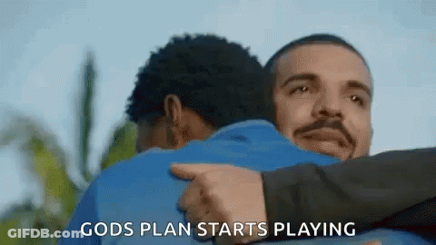 A Man Is Hugging Another Man With The Words `` Gods Plan Starts Playing '' Written On It . GIF