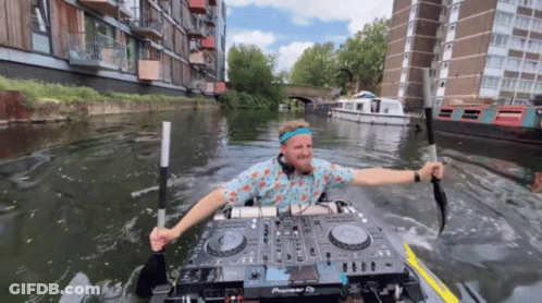 A Man Is In A Kayak With A Pioneer Dj Mixer GIF