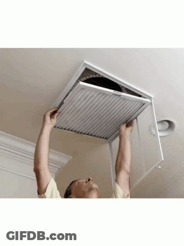 A Man Is Installing A Filter On A Ceiling That Says Emerson GIF