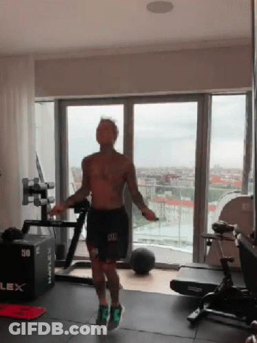 A Man Is Jumping A Jump Rope In A Gym With A Box That Says 50 On It GIF