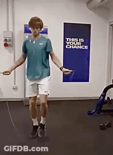 A Man Is Jumping A Jump Rope In Front Of A Sign That Says " This Is Your Chance " GIF