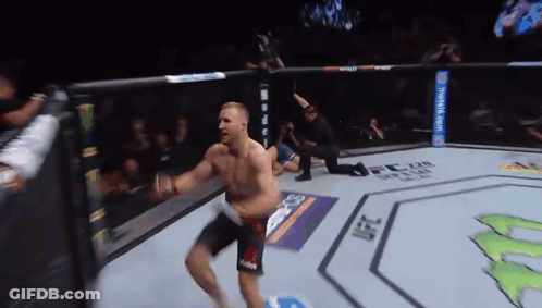 A Man Is Jumping In The Air In A Boxing Ring GIF