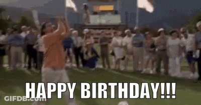 A Man Is Jumping In The Air In Front Of A Crowd While Holding A Microphone And Saying `` Happy Birthday ! '' GIF