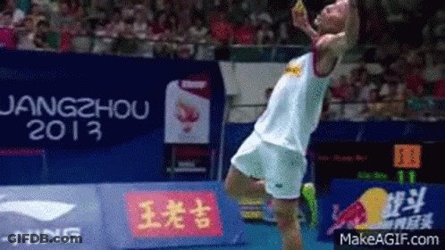 A Man Is Jumping In The Air In Front Of A Sign That Says 2013 GIF