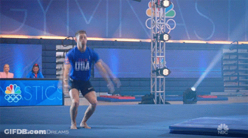 A Man Is Jumping In The Air In Front Of A Sign That Says ' Olympic Dreams ' GIF