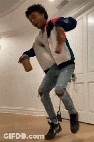 A Man Is Jumping In The Air While Holding A Can Of Peanut Butter . GIF
