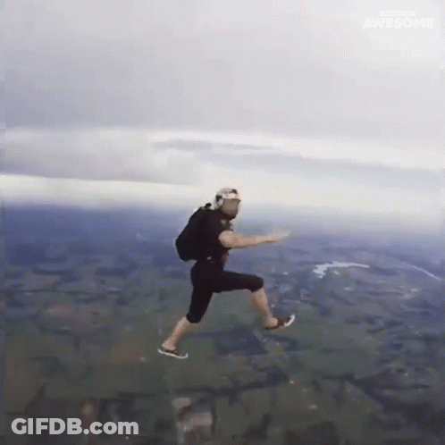 A Man Is Jumping In The Air With A Backpack On His Back GIF