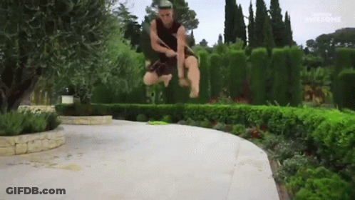 A Man Is Jumping In The Air With A Sword In His Hand And The Word Awesome Is Visible In The Corner GIF