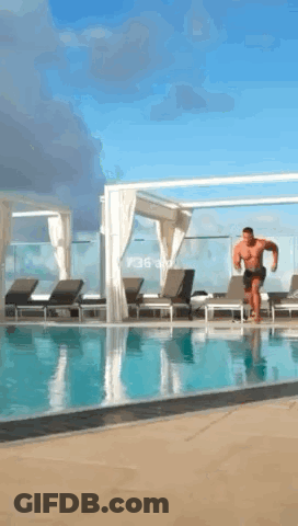 A Man Is Jumping Into A Swimming Pool At 1:36 GIF