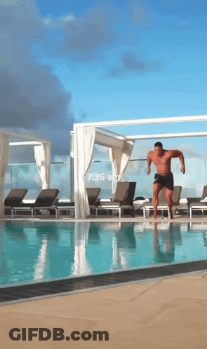 A Man Is Jumping Into A Swimming Pool With A Time Of 6:36 GIF