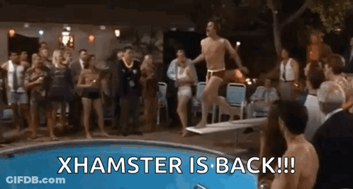 A Man Is Jumping Off A Diving Board Into A Pool While A Group Of People Watch . GIF
