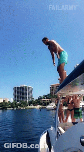 A Man Is Jumping Off The Side Of A Boat With Failarmy In The Corner GIF