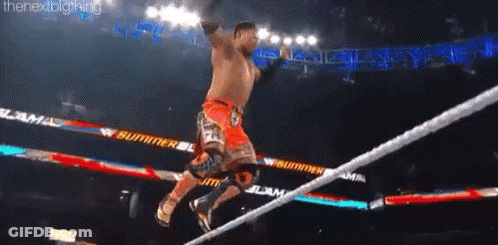 A Man Is Jumping Over A Rope During A Wrestling Match GIF