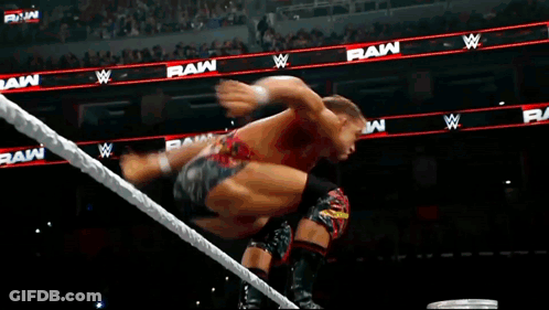 A Man Is Jumping Over A Rope In A Wrestling Ring With The Word Raw In The Background GIF