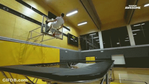 A Man Is Jumping Over A Trampoline In A Gym With The Words Awesome On The Bottom Right GIF