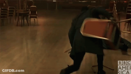 A Man Is Kicking A Chair In A Room With Bbc America Written On The Bottom Right GIF