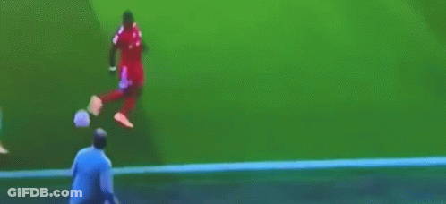 A Man Is Kicking A Soccer Ball On The Field GIF