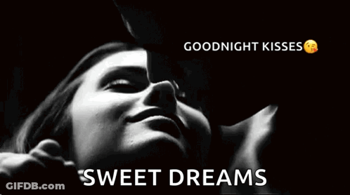 A Man Is Kissing A Woman On The Cheek In A Black And White Photo With The Words `` Goodnight Kisses Sweet Dreams '' . GIF