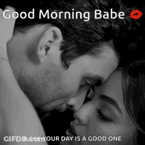 A Man Is Kissing A Woman On The Forehead . GIF